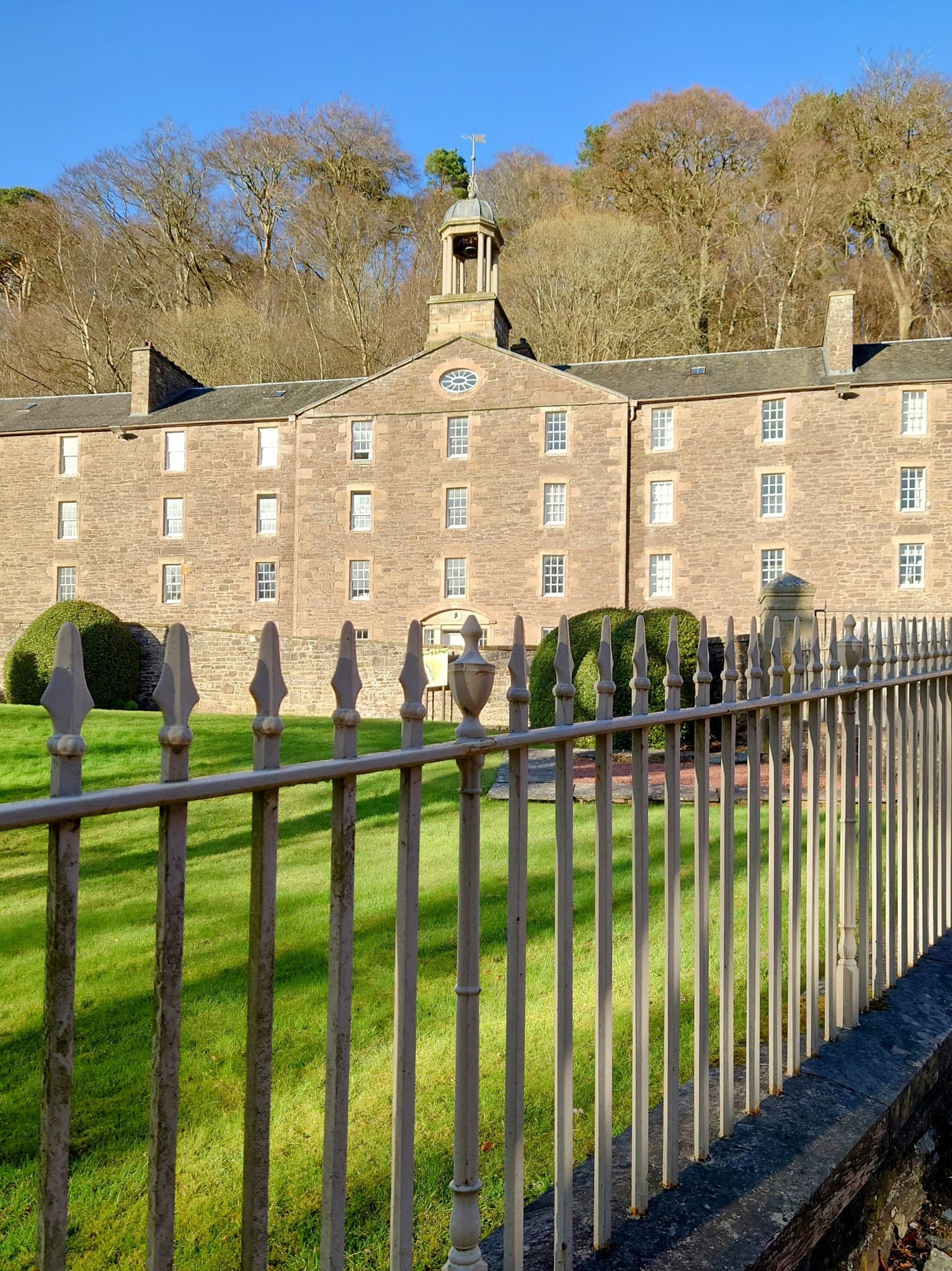 Historic cotton mill complex and workers' housing at New Lanark along the River Clyde.