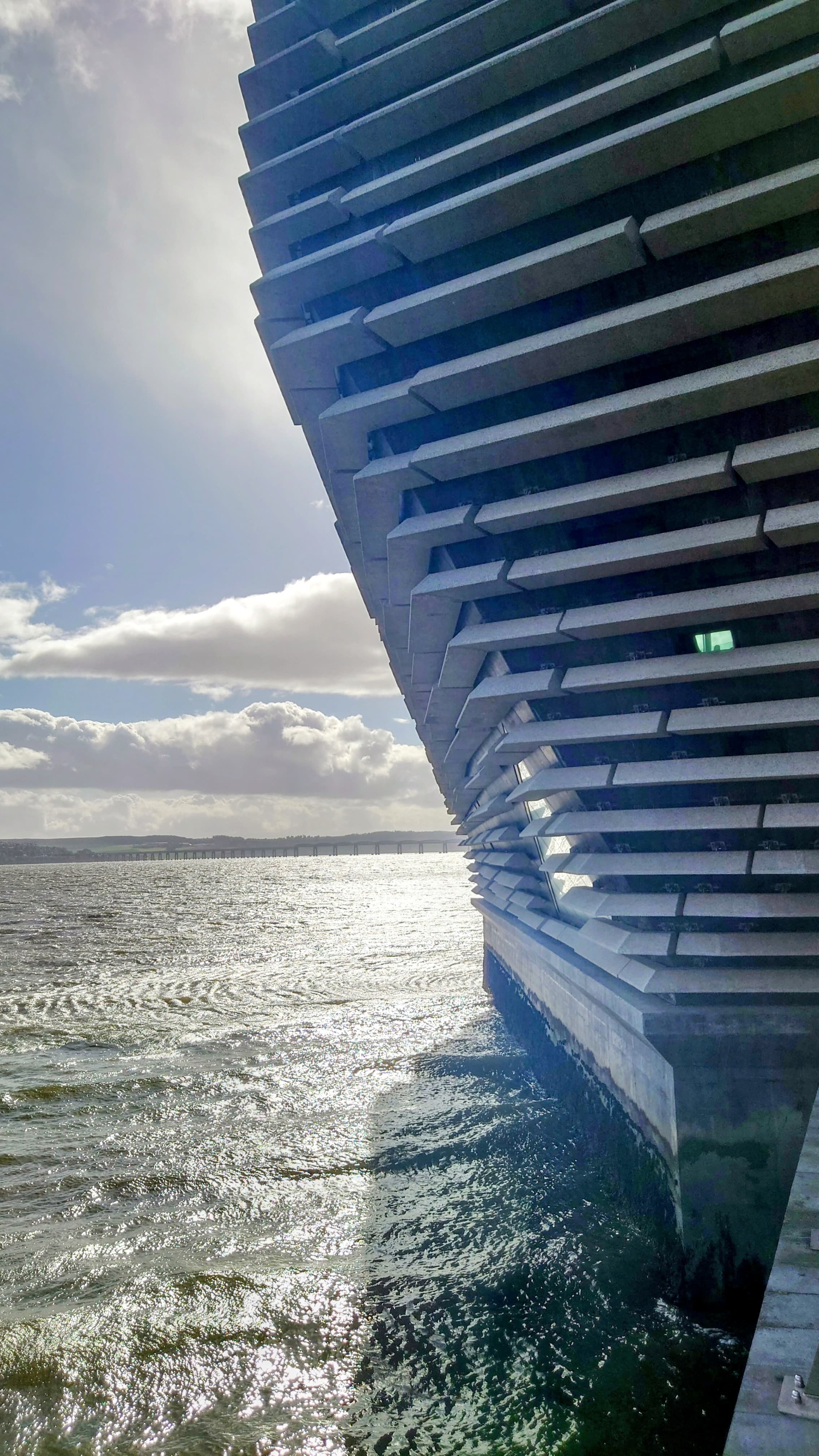 V&A Dundee geometric concrete facade reflecting on the River Tay waterfront.