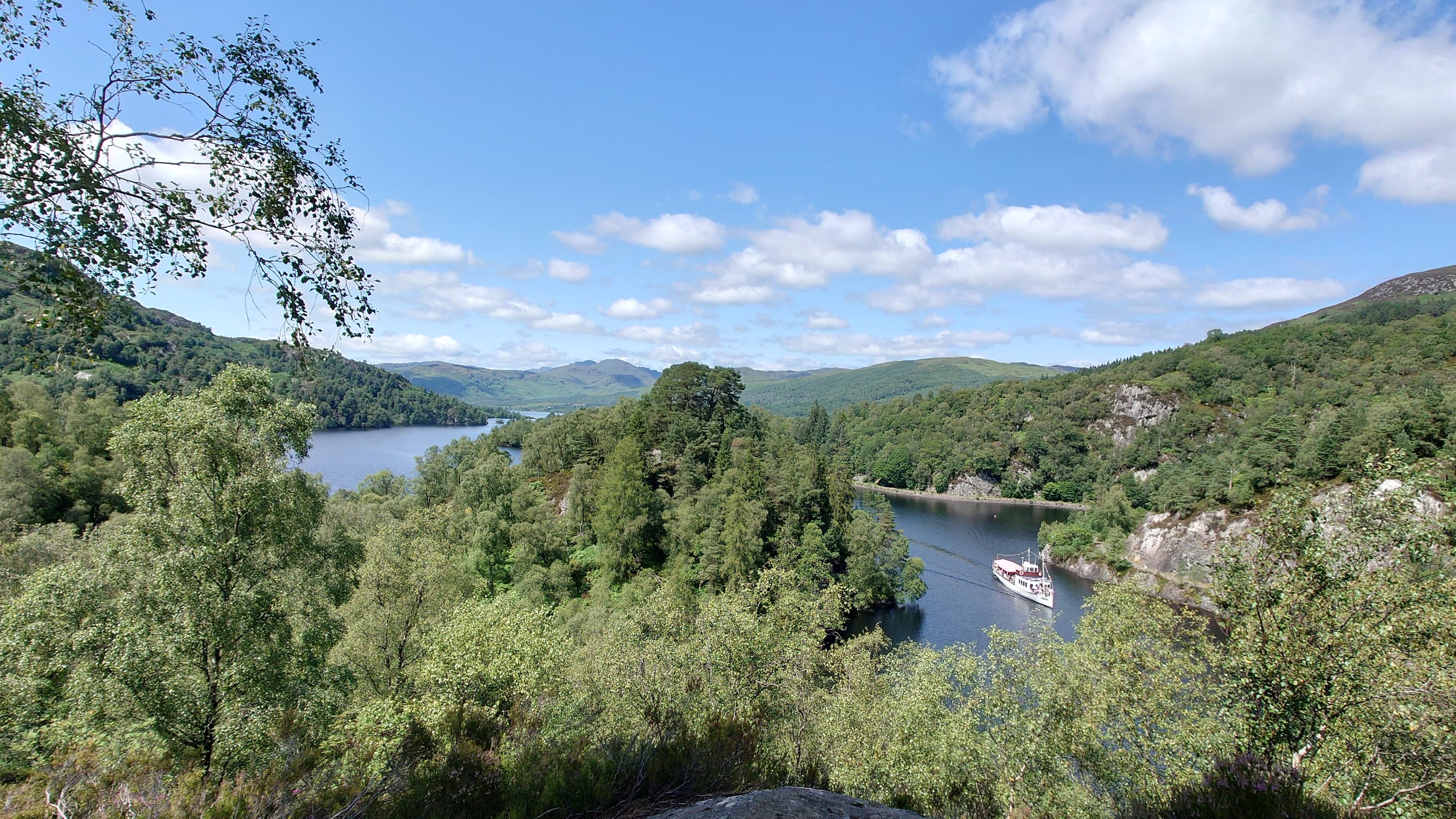 Loch Katrine waters and wooded Highland shorelines in the Trossachs.