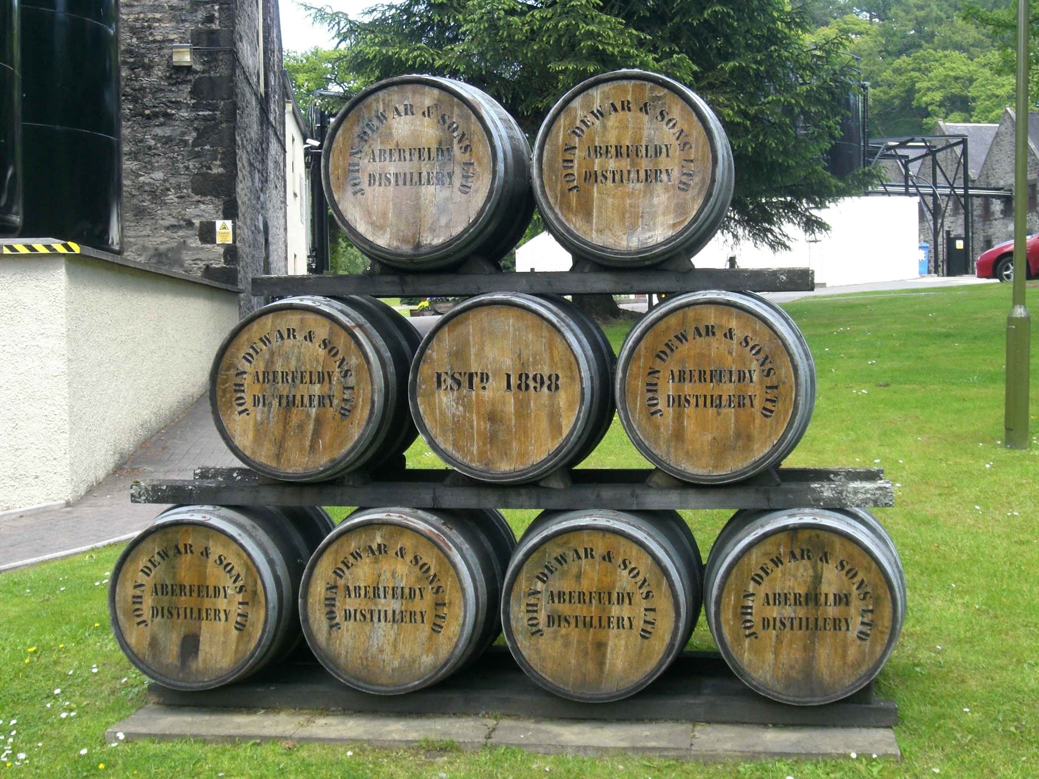 Whisky casks stacked inside Aberfeldy Distillery warehouse.