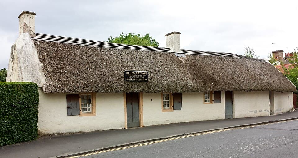 Thatched roof and whitewashed stone vernacular cottage of Robert Burns birthplace.