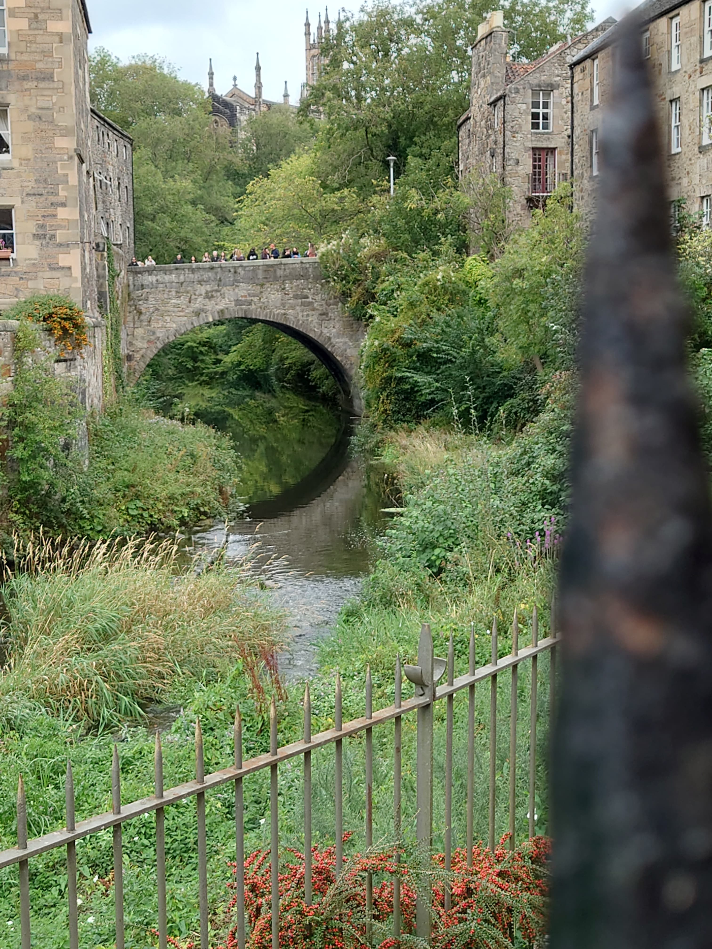 Historic stone mill buildings and river bridge in Dean Village by the Water of Leith