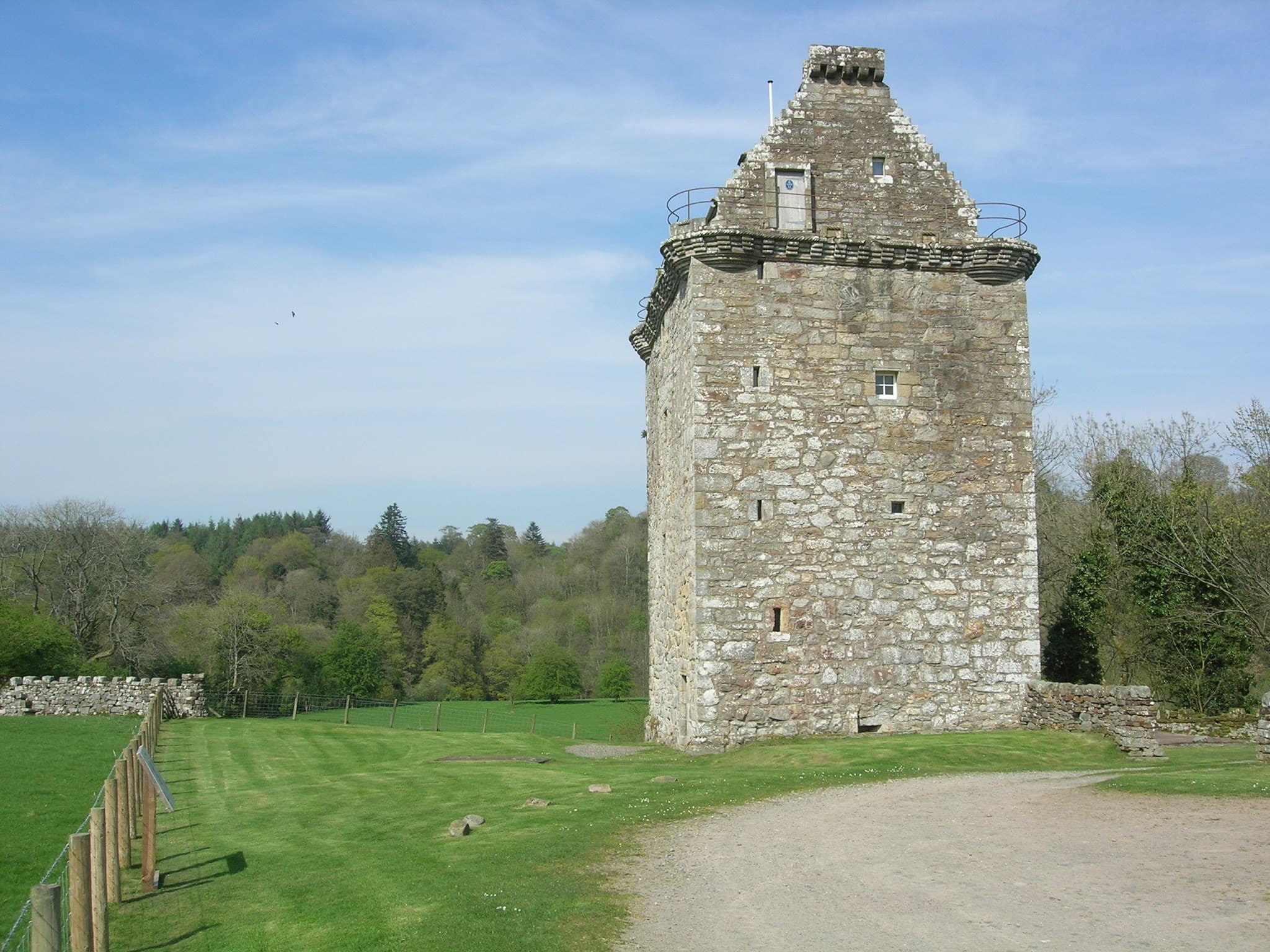 Stone pele tower of Gilnockie Tower standing beside the River Esk.