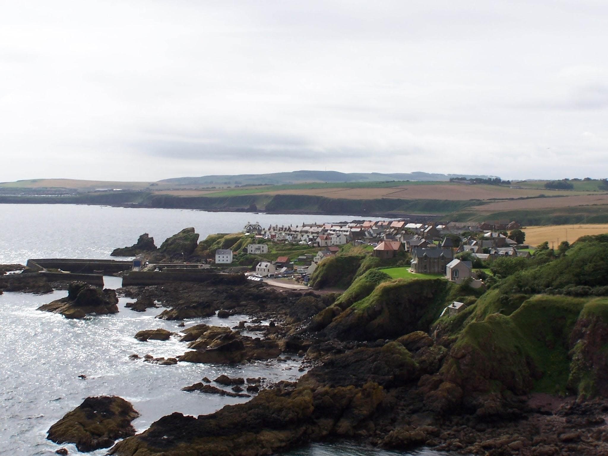 St Abbs village and working harbour seen from St Abb's Head cliffs.