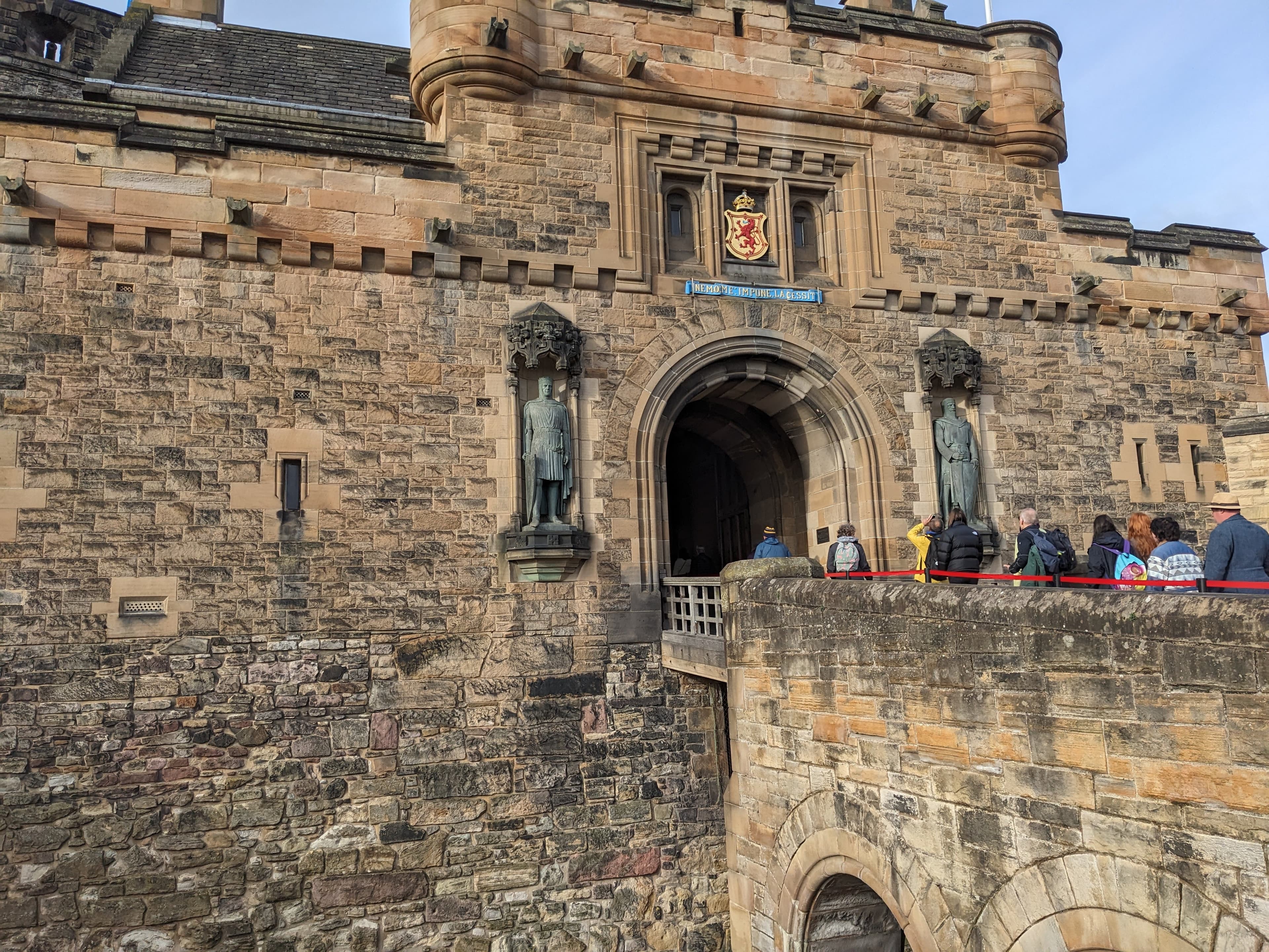 The imposing stone gatehouse and battlements of Edinburgh Castle.
