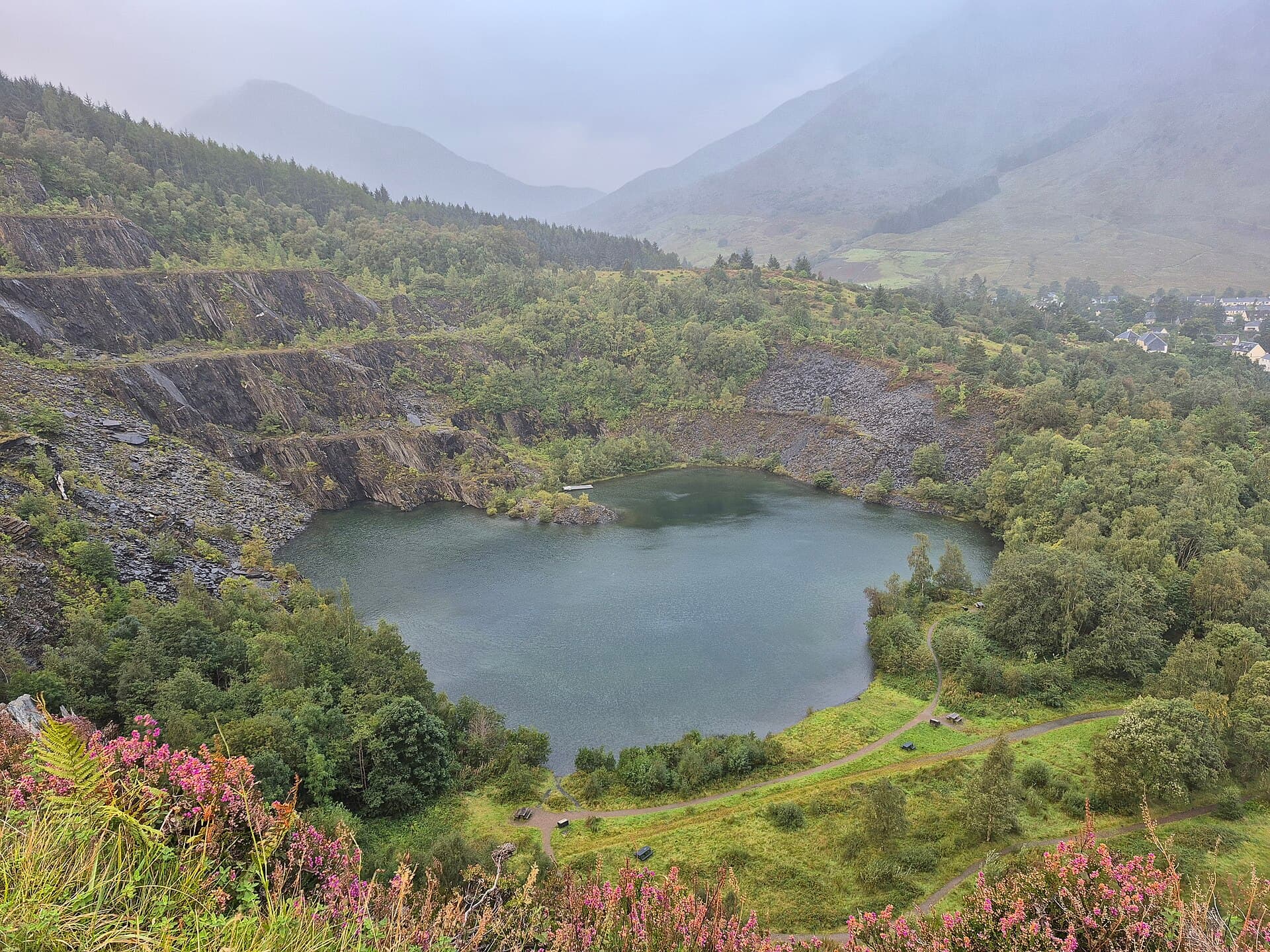 The flooded amphitheatre and dramatic vertical rock faces of the historic Ballachulish disused slate quarry