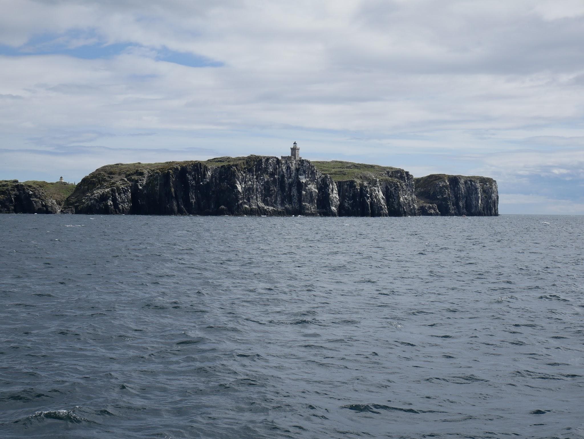 The rocky shores, lighthouse and seabird nesting cliffs of the Isle of May.