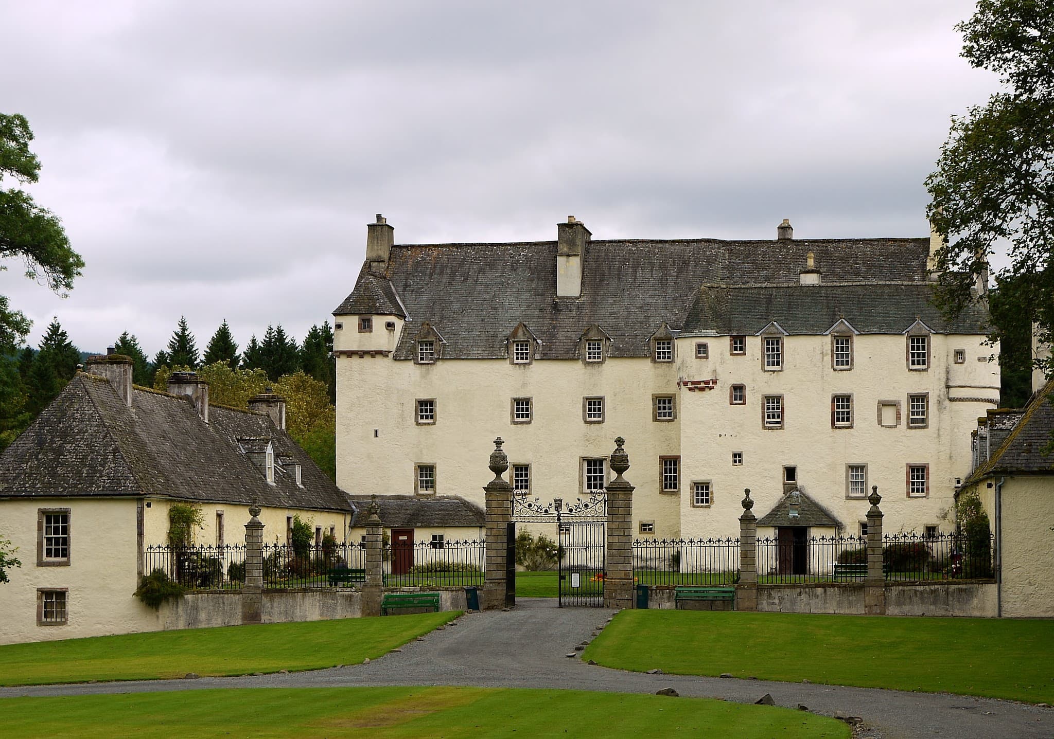 Historic whitewashed facade and steep roofs of Traquair House.