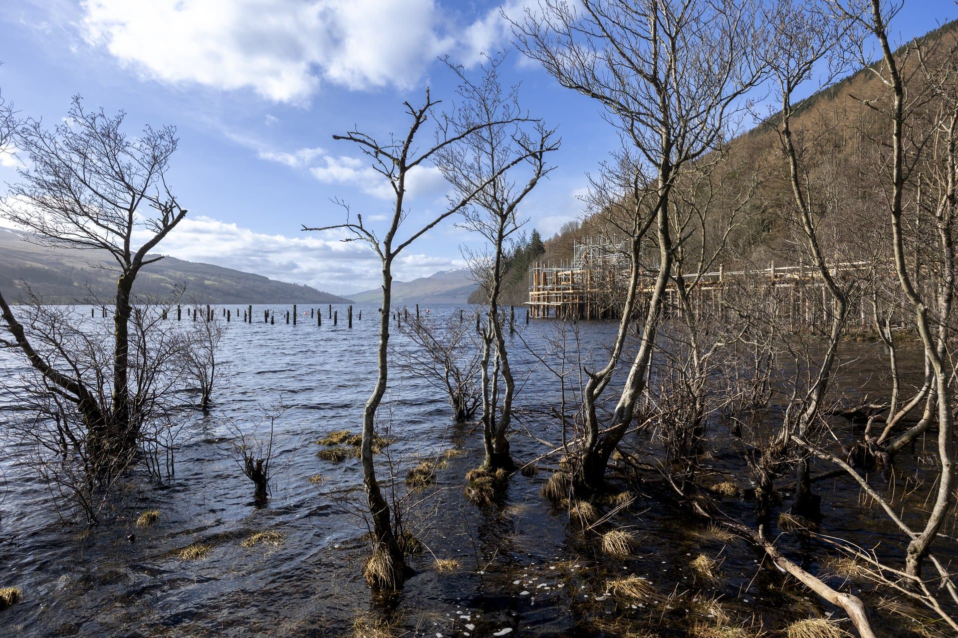 Reconstructed Iron Age timber roundhouse and walkway over water at The Scottish Crannog Centre, Loch Tay