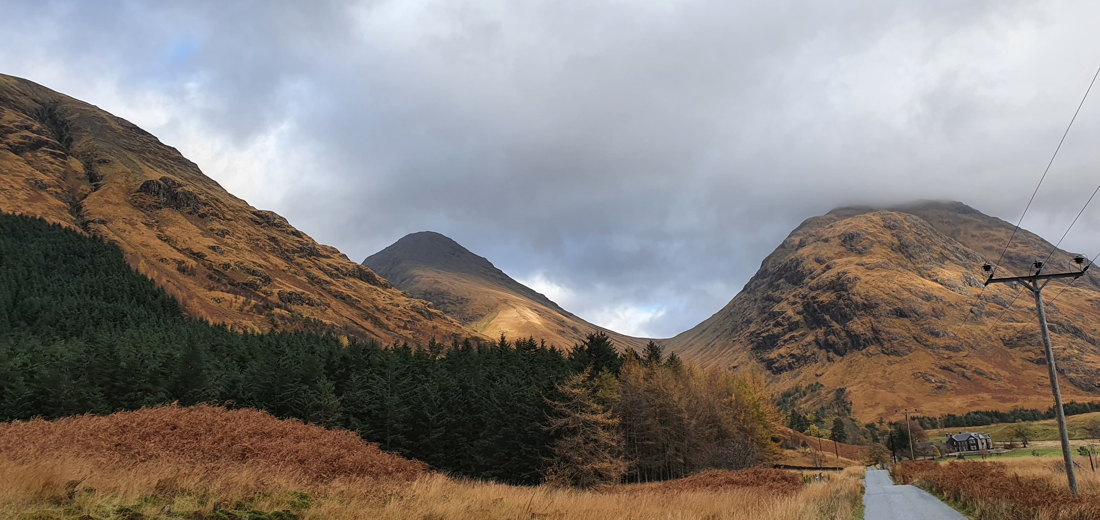 Autumn colours across Glen Etive with mountains rising beyond the glen.