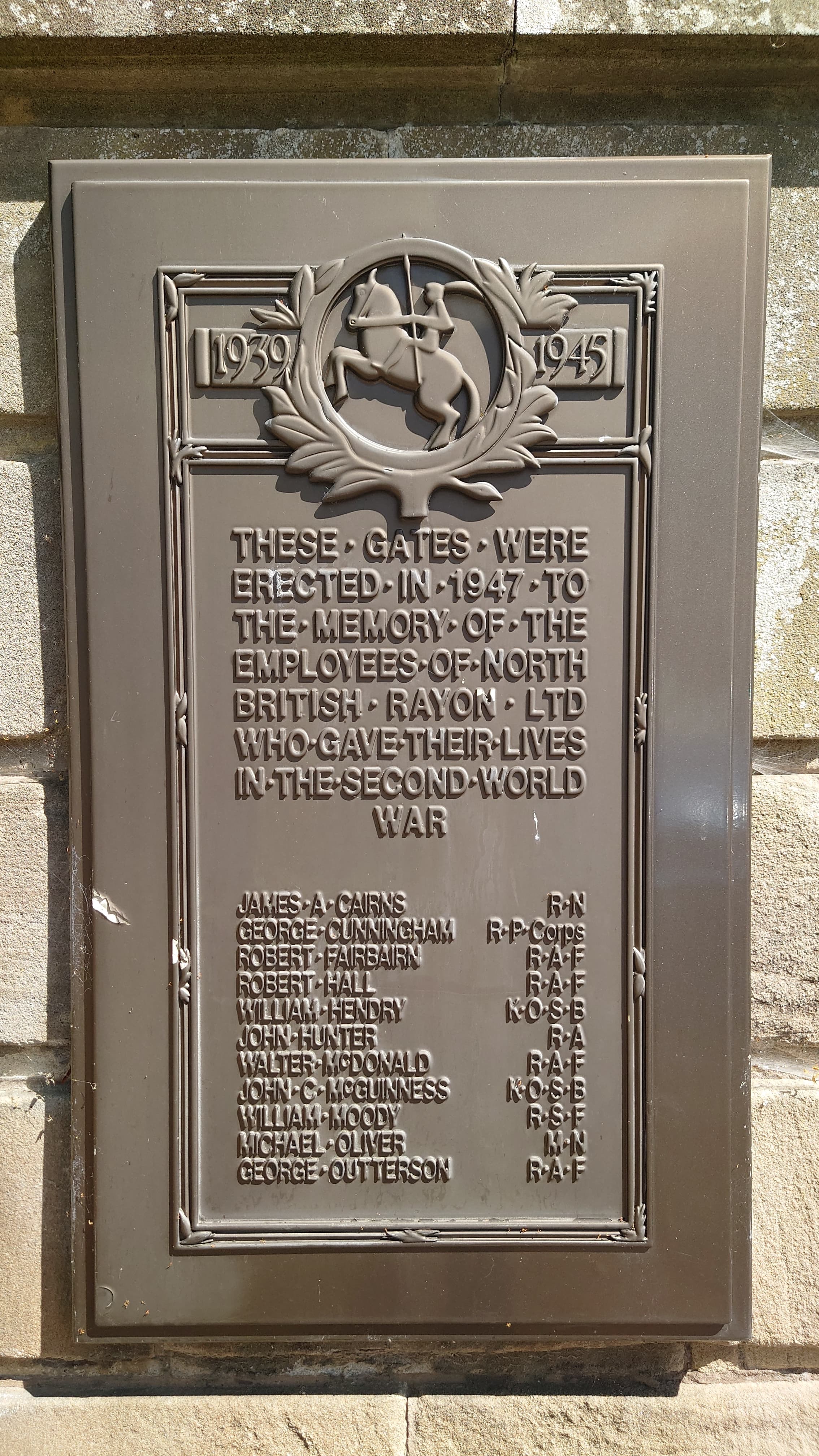 Memorial plaque at the former North British Rayon gates in Jedburgh, commemorating employees who died in the Second World War.